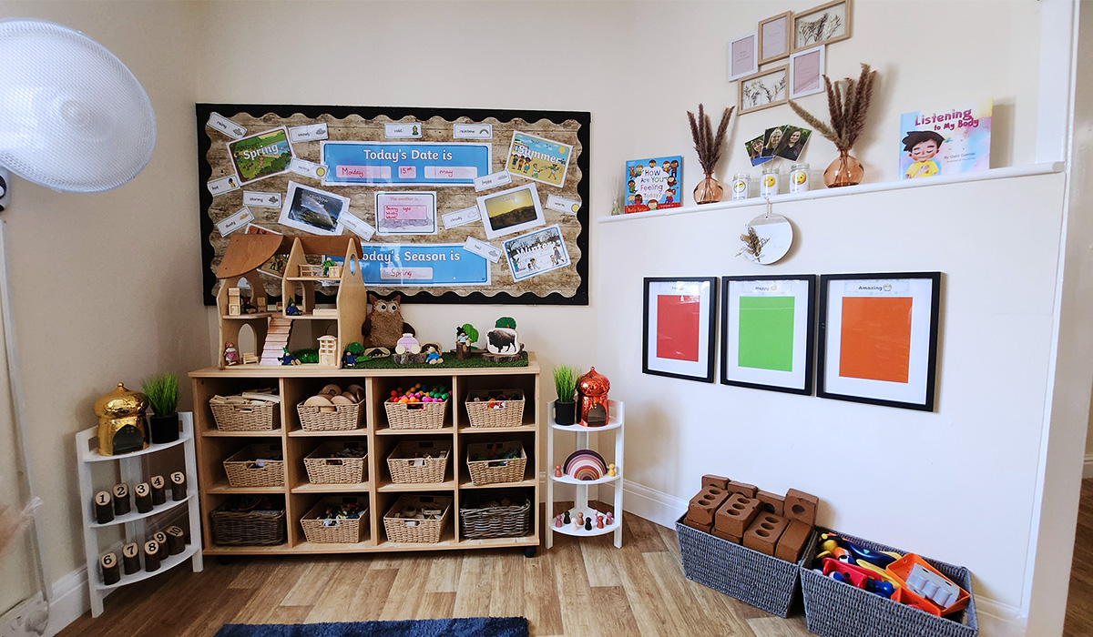 Wooden storage unit with wicker toy baskets at Partou Acorns in Adel nursery and pre-school in Leeds