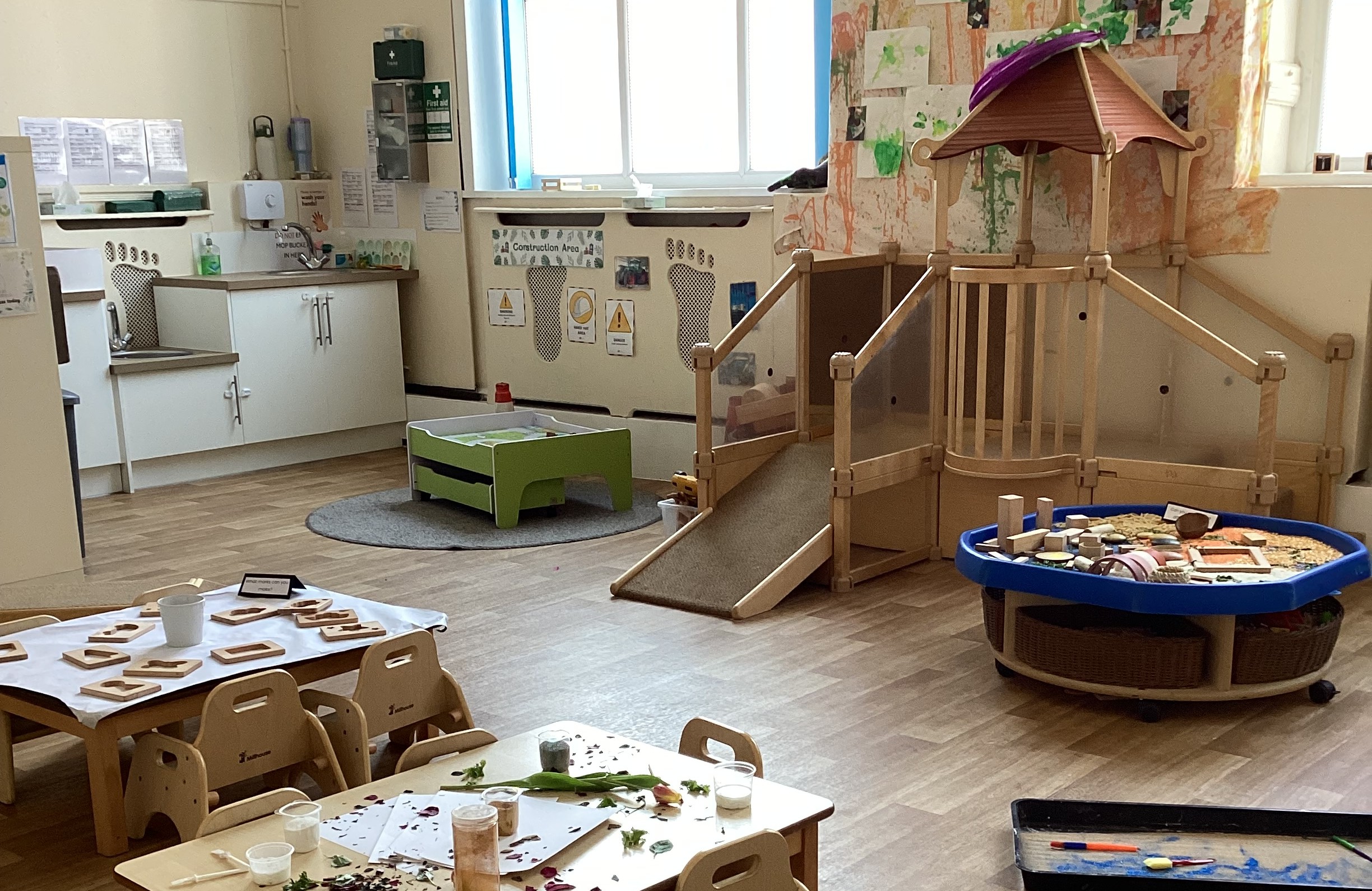 Wooden climbing structure for toddlers and sensory activities set up at Partou Footprints nursery in Atherton