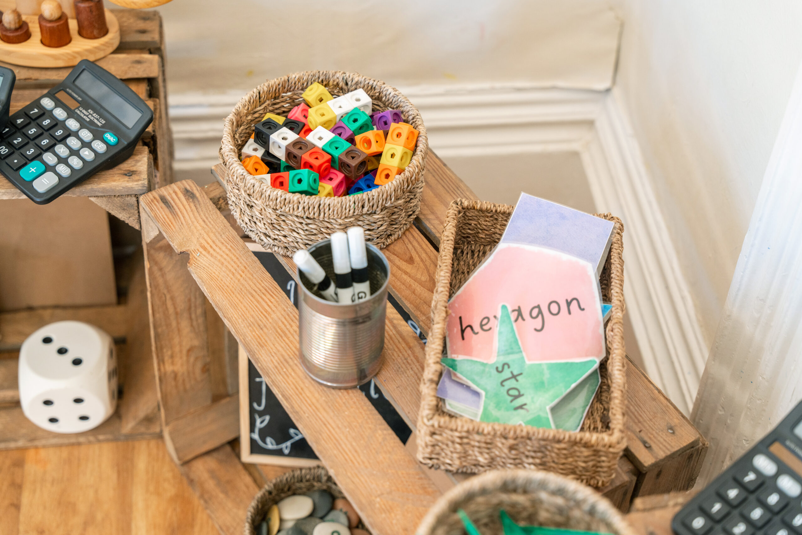Numeracy play area at Hilltops nursery in Chorley with number cubes, calculators and assorted shapes