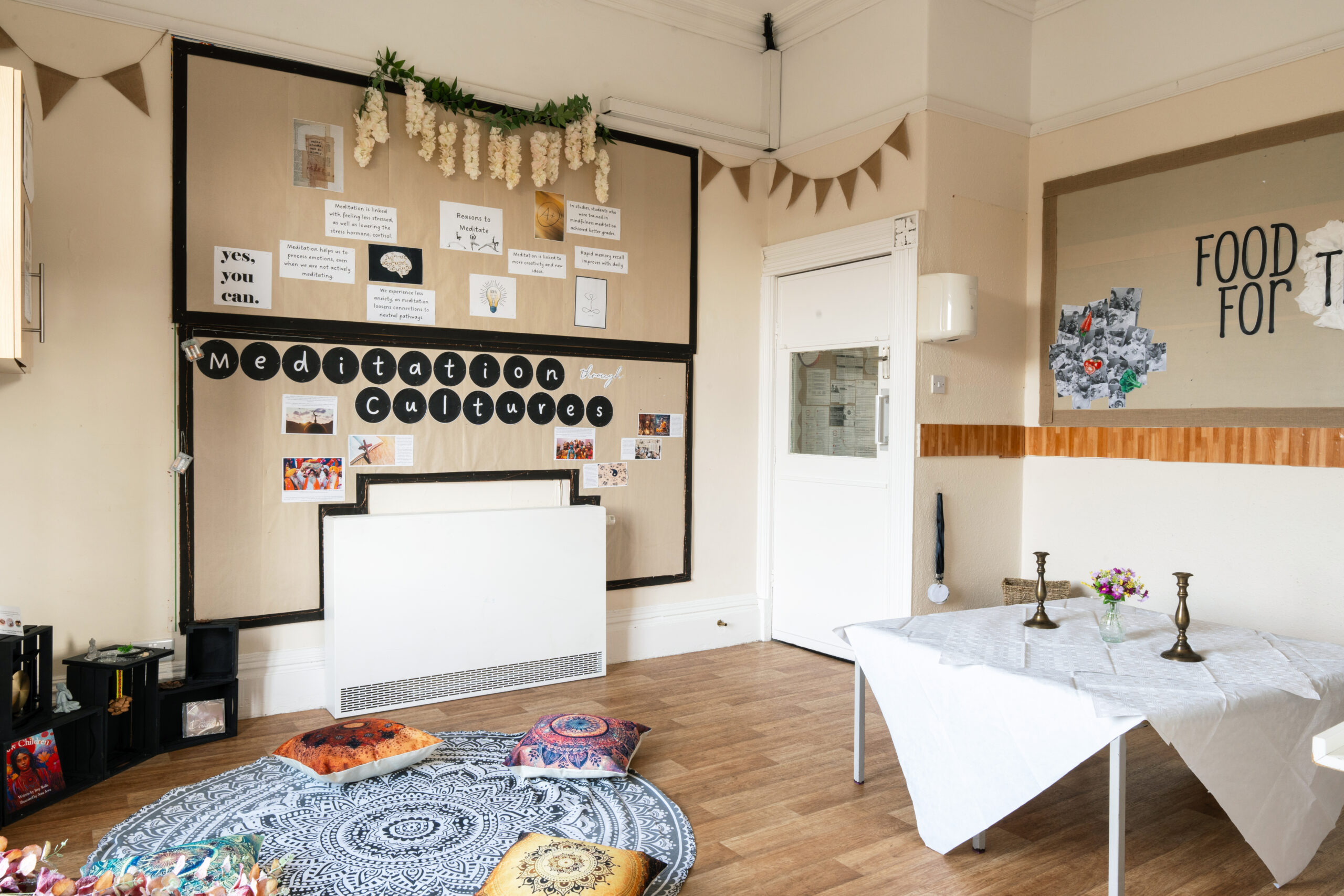 Meditation corner at Hilltops nursery in Chorley with mat and cushions and wall display about meditation cultures