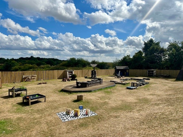 Large garden area with wooden play structures at Partou Langley Gorse Day Nursery in Sutton Coldfield
