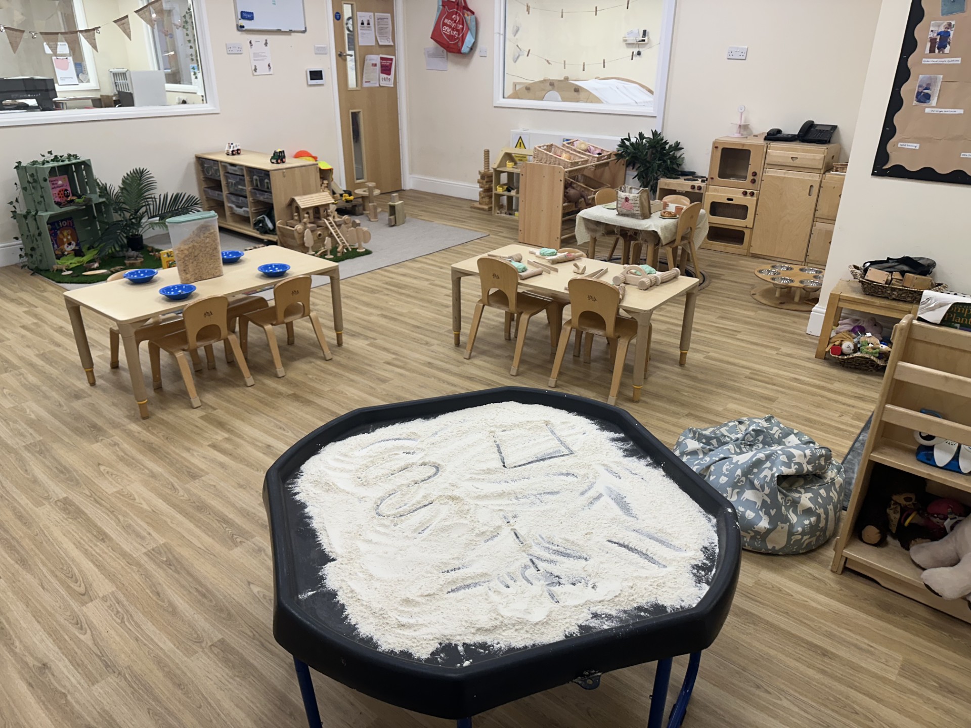 Tough tray with white sand for mark making at Partou Upton Day Nursery in Prenton