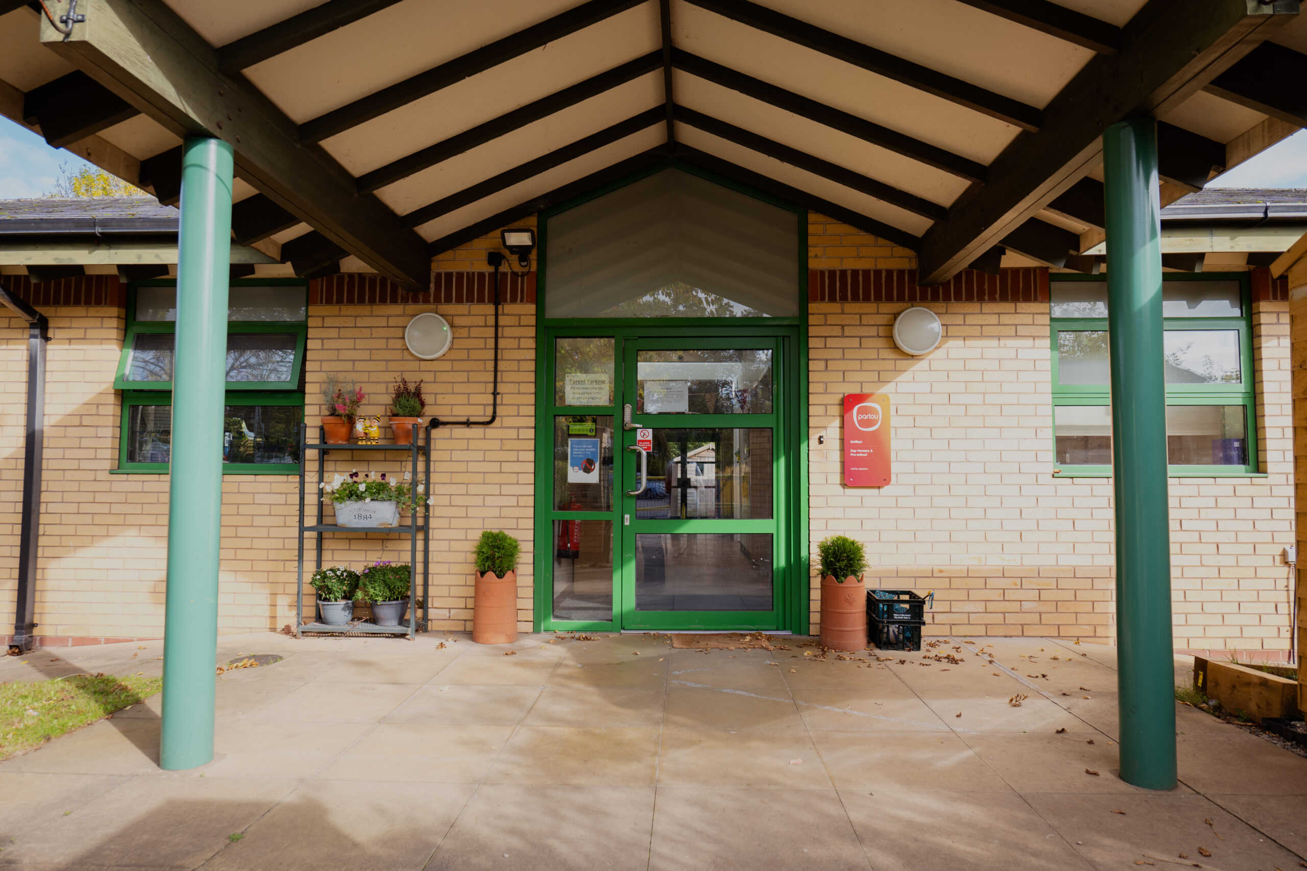 Entrance to Smileys nursery in Stafford with green door and pillars