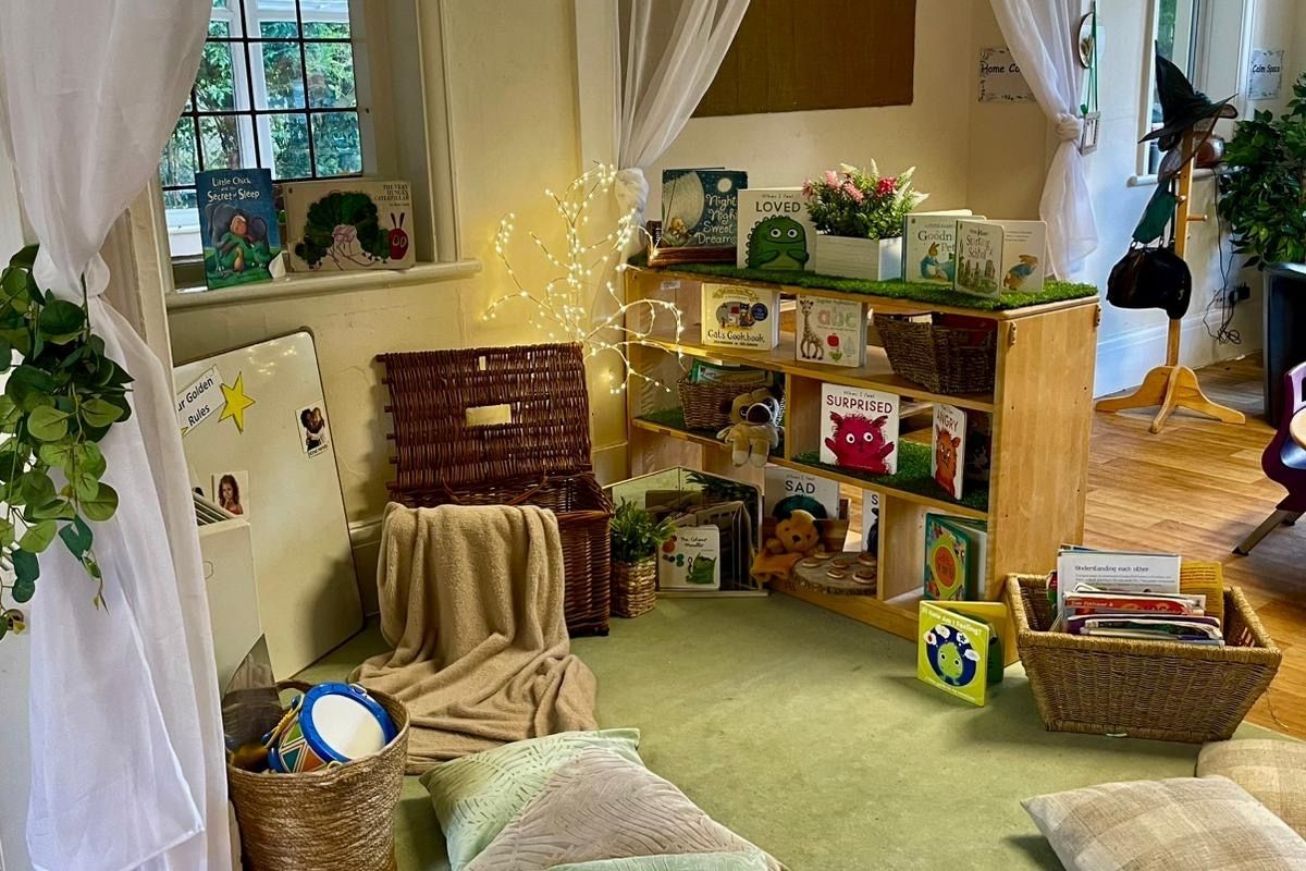Pre-School reading area with green rug and green and grey cushions and warm coloured twinkly lights at Partou Cherubs Day Nursery & Pre-School in Cheshire