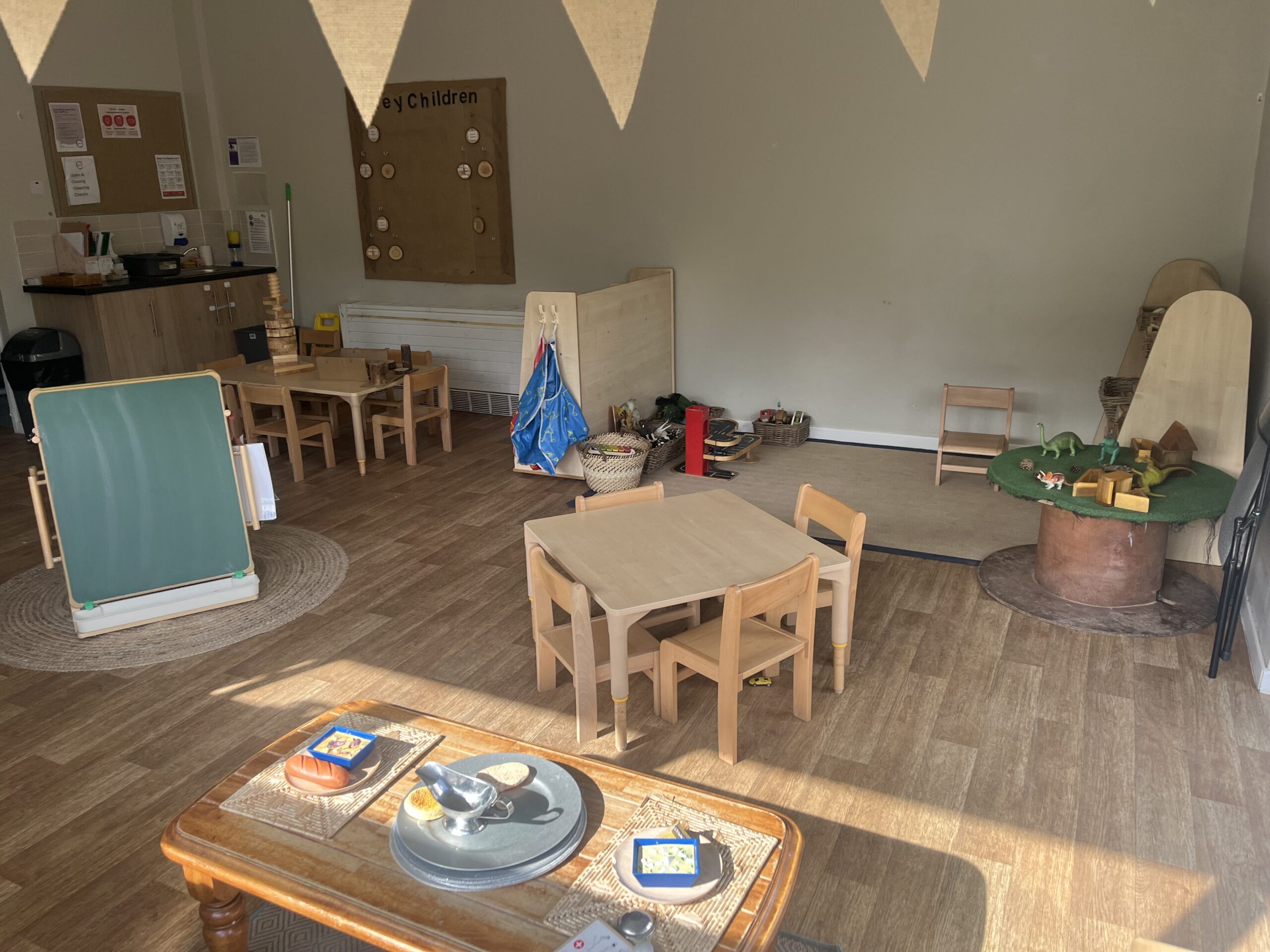Wooden table and chairs surrounded by natural material children