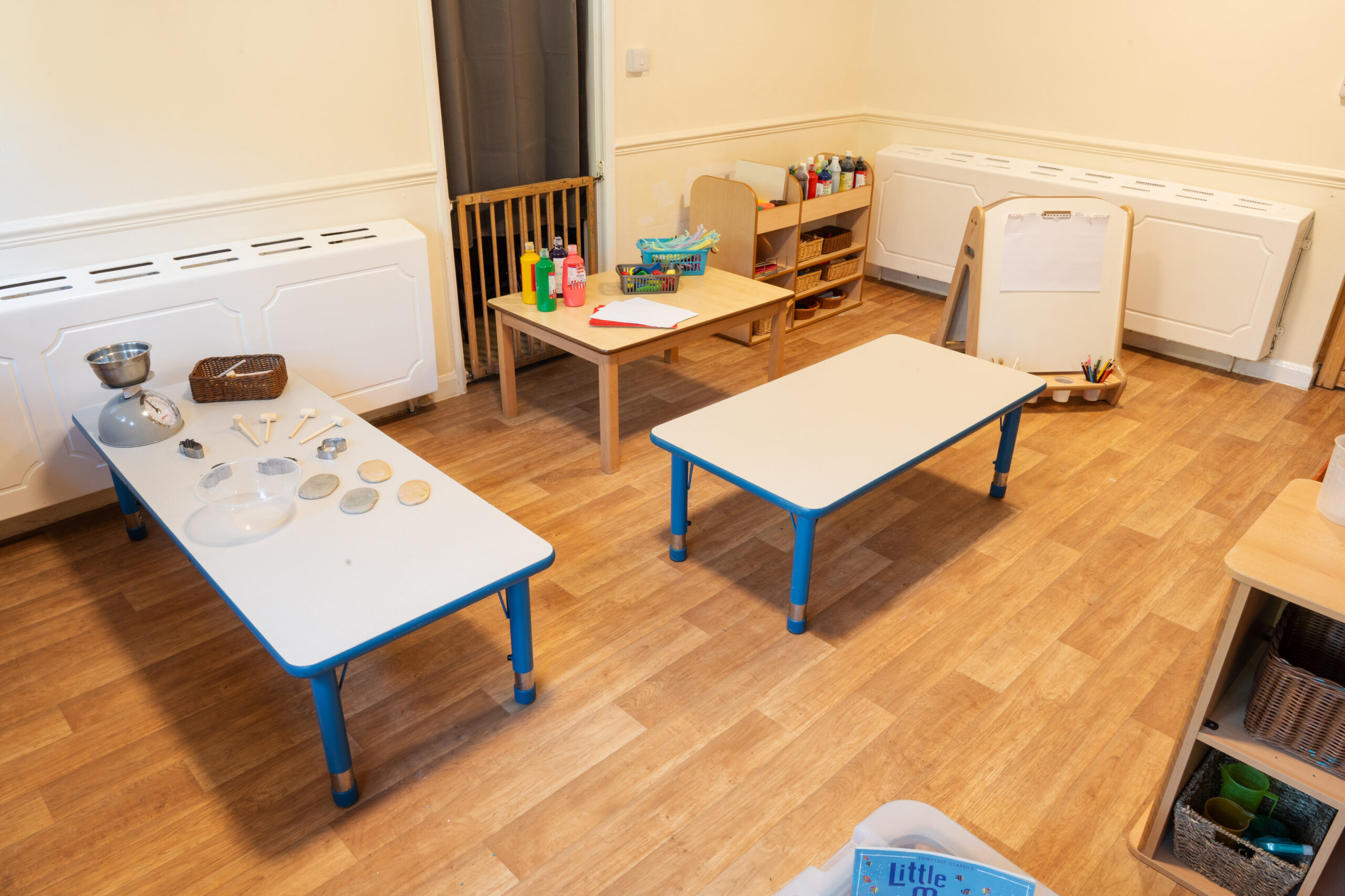Artistic area at Safehands nursery in Harrogate with painting table and art supplies
