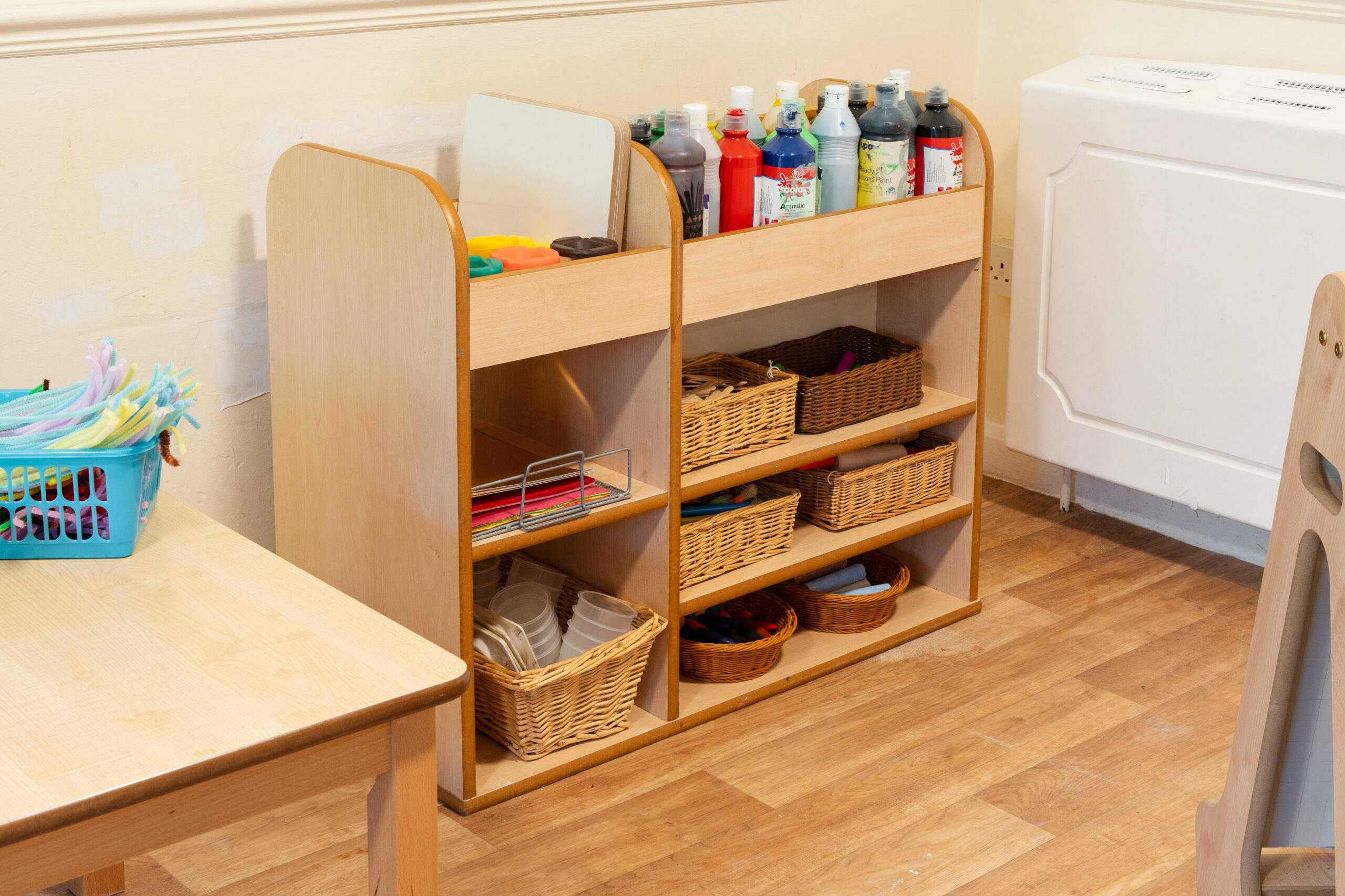 Art supplies including paint, pots and paper stored safely at Safehands nursery in Harrogate