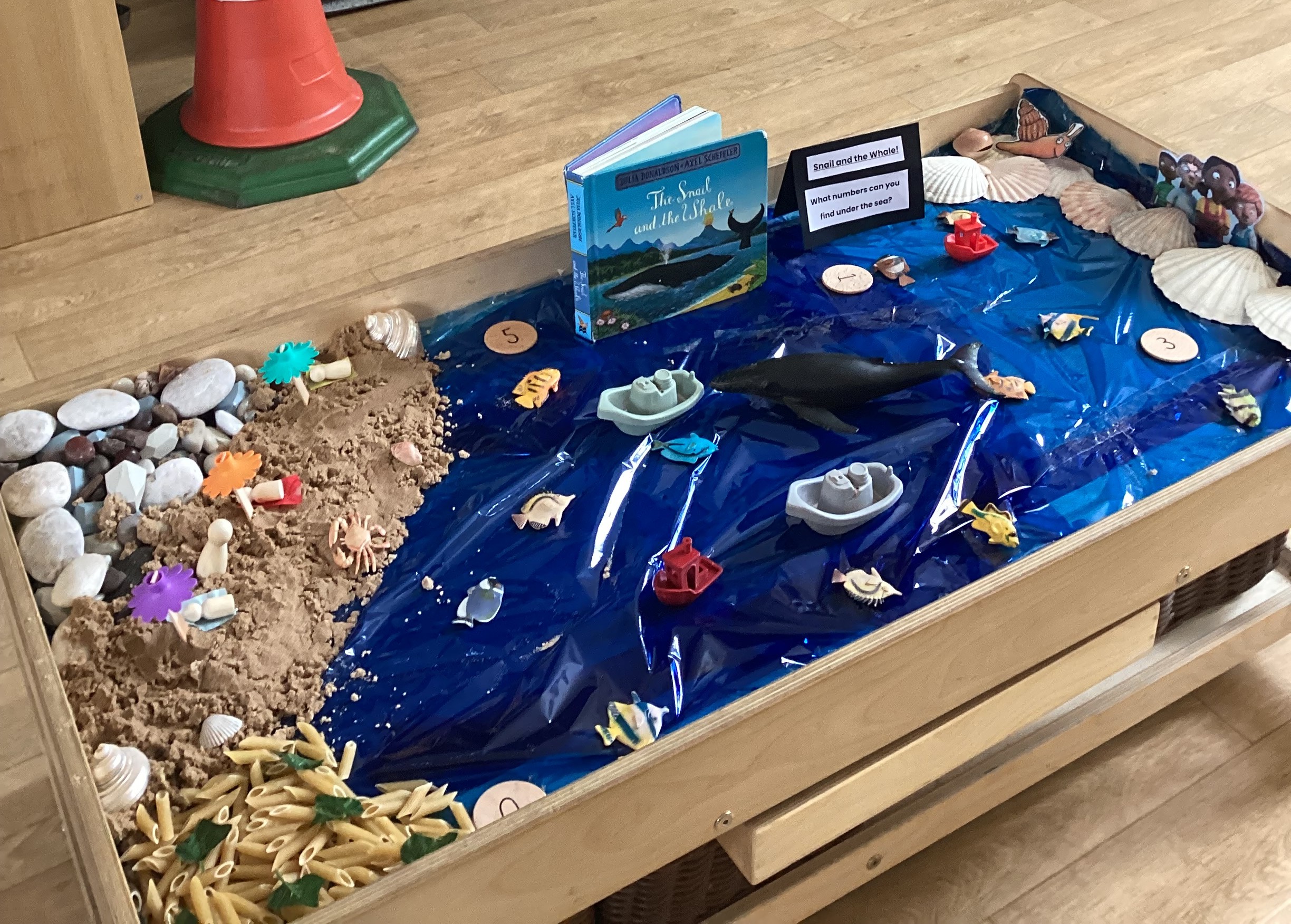 Sea themed snail and the whale sensory activity with sand, pasta and nautical toys at Partou Footrpints nursery in Atherton
