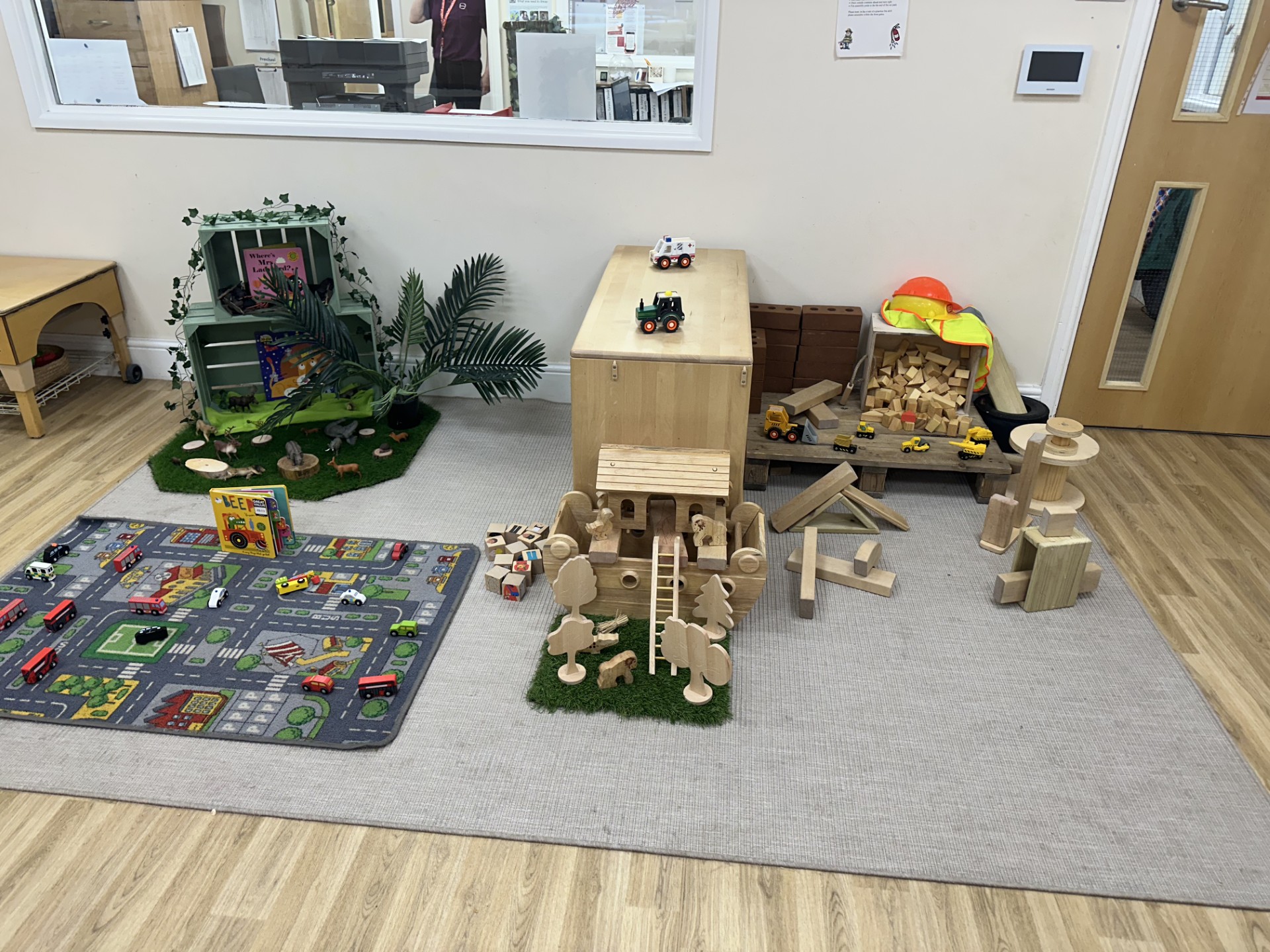 Cars and road mat play area next to construction toys at Partou Upton Day Nursery in Prenton, Birkinhead