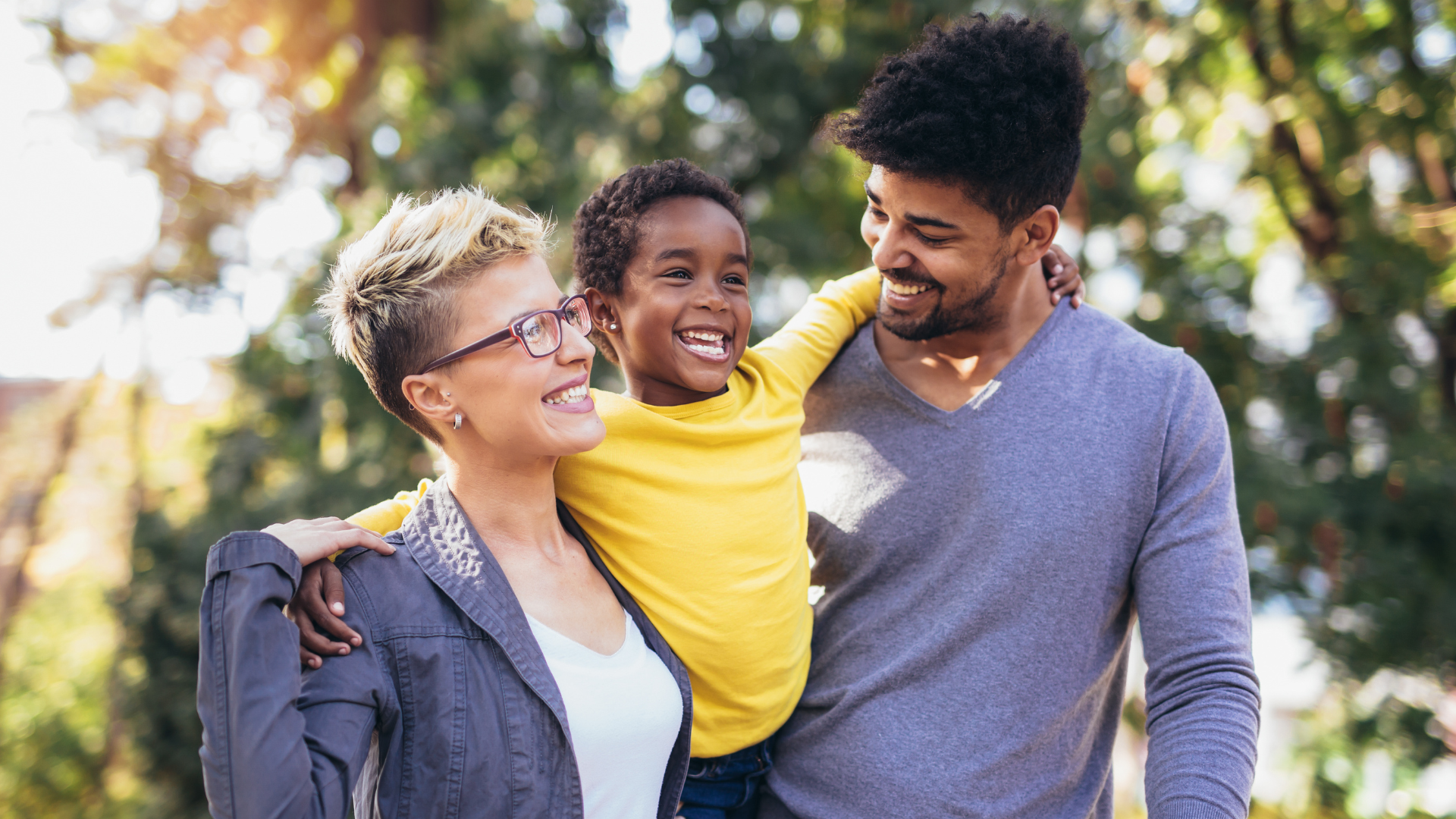 Young mixed race family enjoying time with their child
