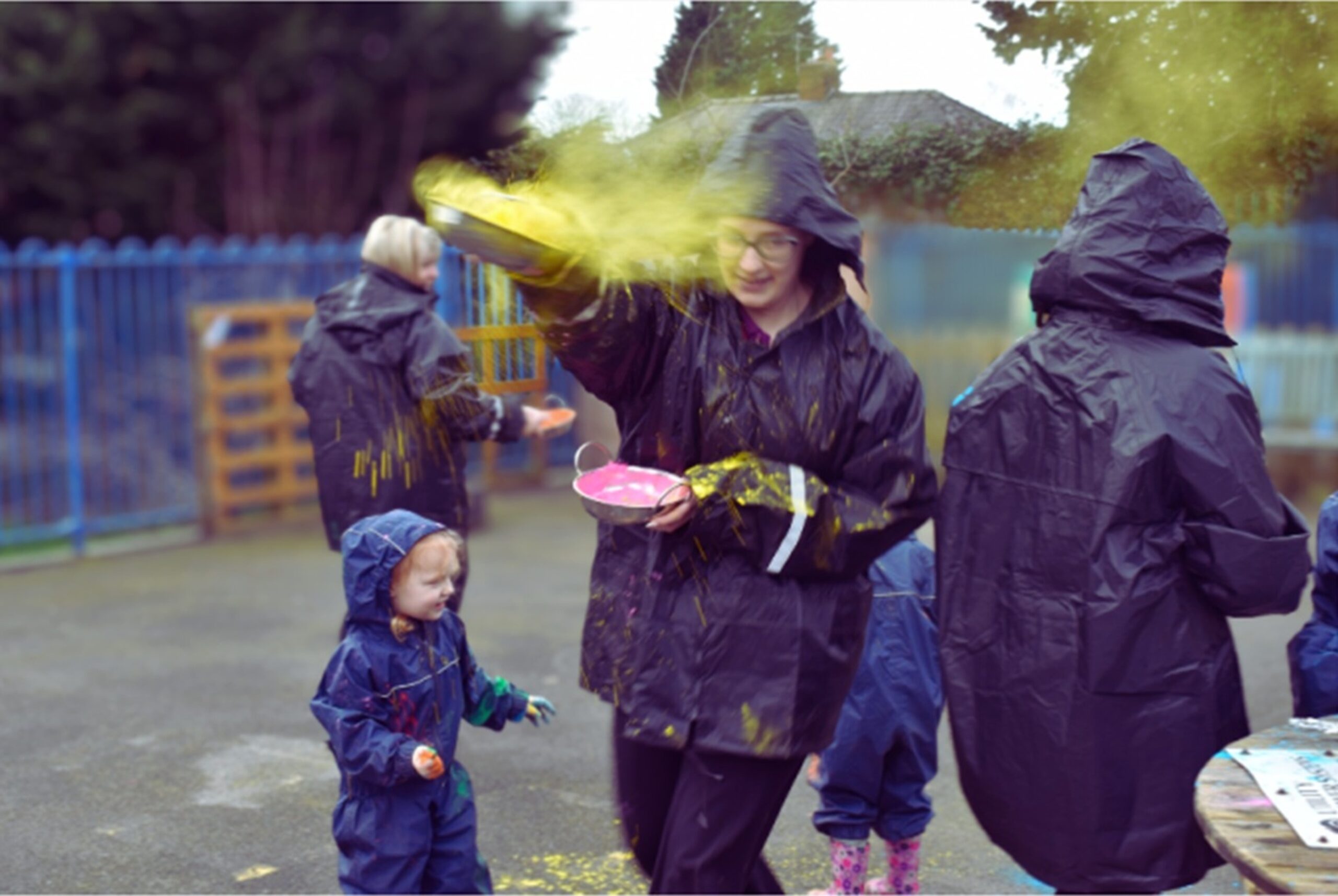 Children and childcare practitioners at Partou Stonehouse Day Nursery & Pre‑school in Leyland take part in a UNICEF colour run, with coloured powder thrown during an outdoor fundraising even