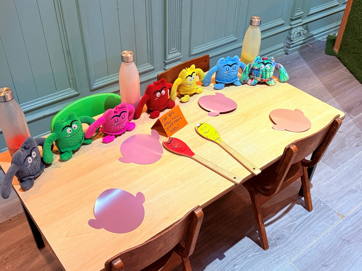 Emotional recognition activity at Partou The Railway Euxton Day Nursery with plush characters, coloured cutouts and playful learning prompts