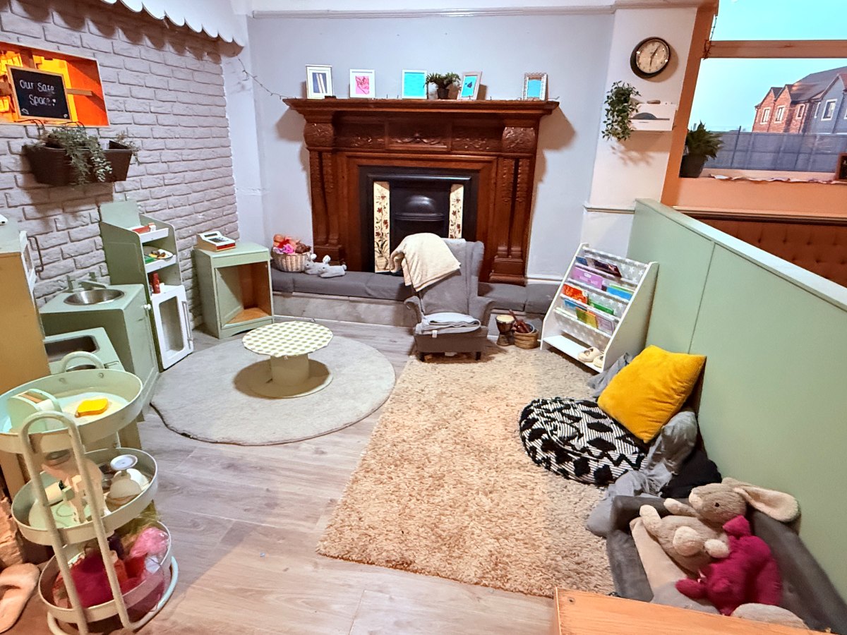 Cosy early years room at Partou The Railway Euxton Day Nursery with play kitchen, reading corner and soft seating