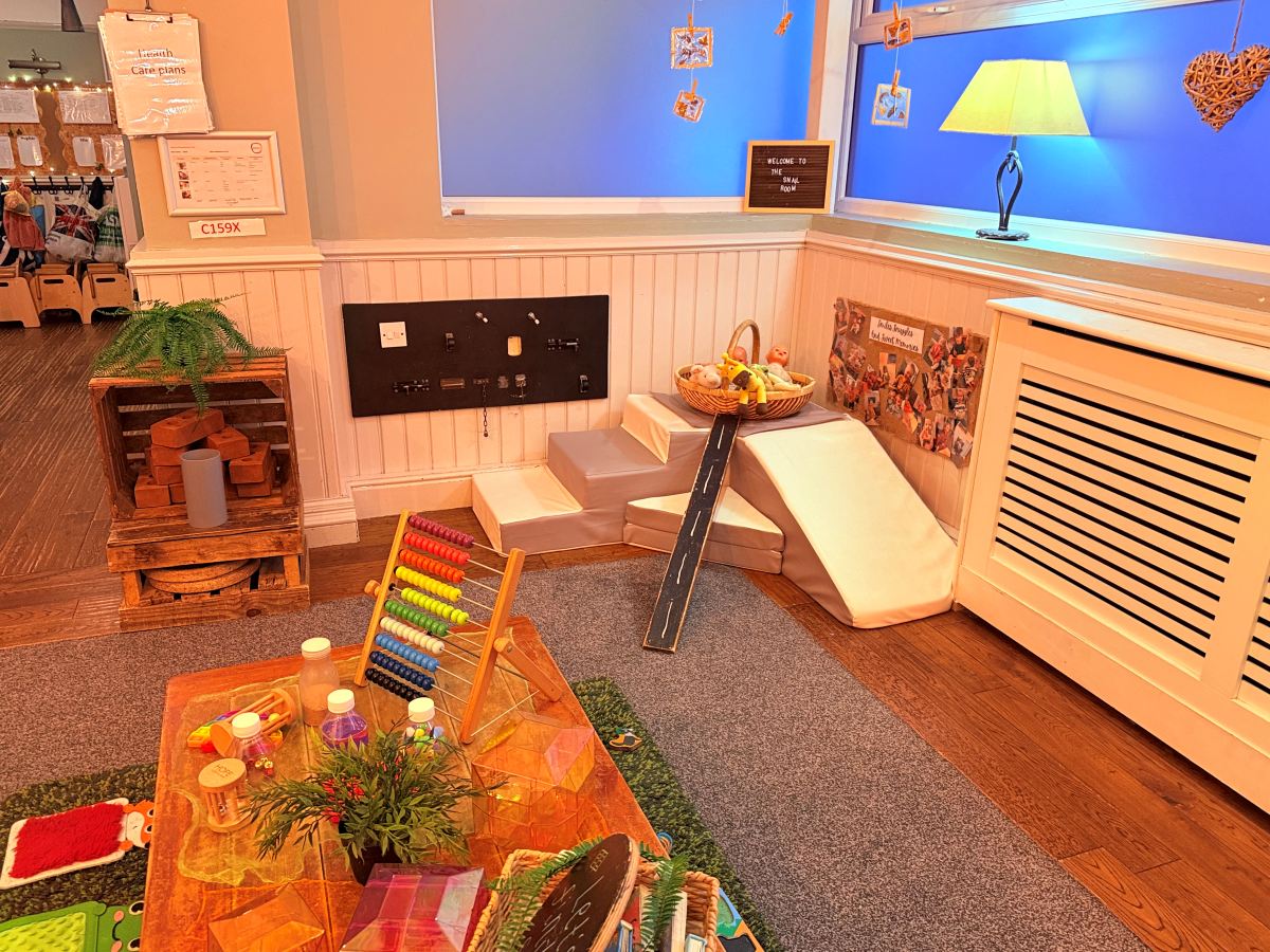 Baby room at Partou The Railway Euxton Day Nursery with sensory toys, soft‑play steps and engaging early learning resources