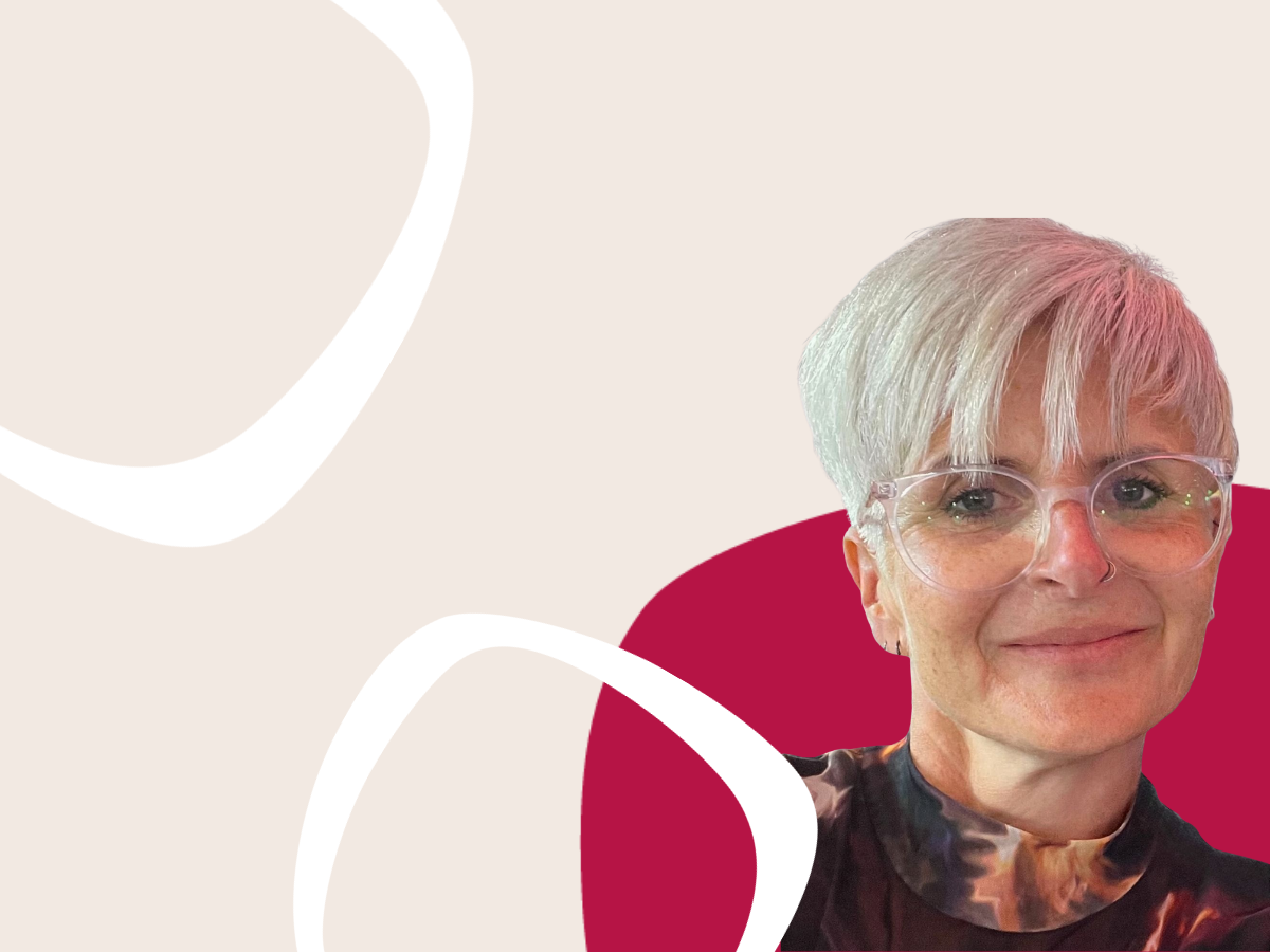 Header image of a person with short light hair and clear-framed glasses on a cream background with abstract white shapes and a dark pink graphic element.