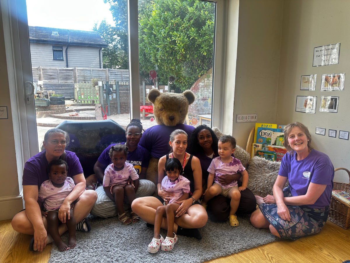 Partou Gingerbread House Day Nursery & Pre-School in South Croydon celebrates International Friendship Day with the South East Cancer Help Centre, as children and staff gather with a charity representative and teddy bear to support the local community.