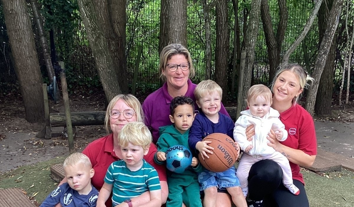 Children and team members at Partou Thornbury Day Nursery & Pre-School gather together in the nursery